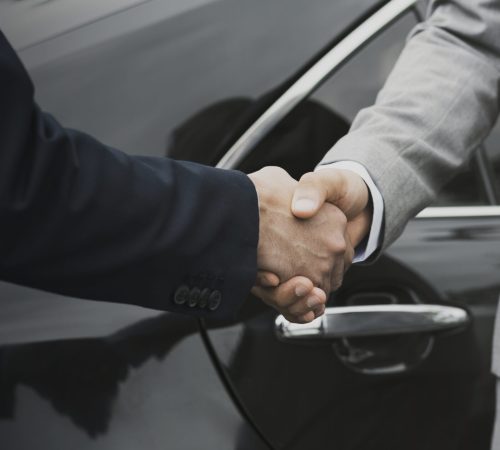 Corporate-Transfers Businessmen greeting by shaking hands